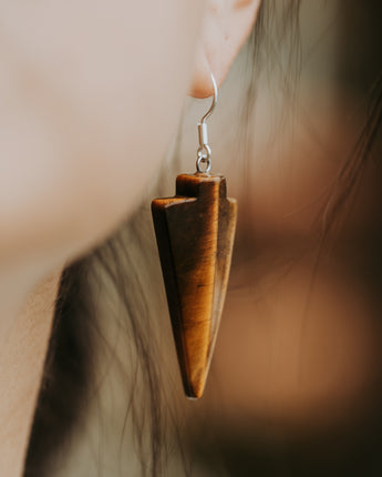 woman wearing stone dangle earrings